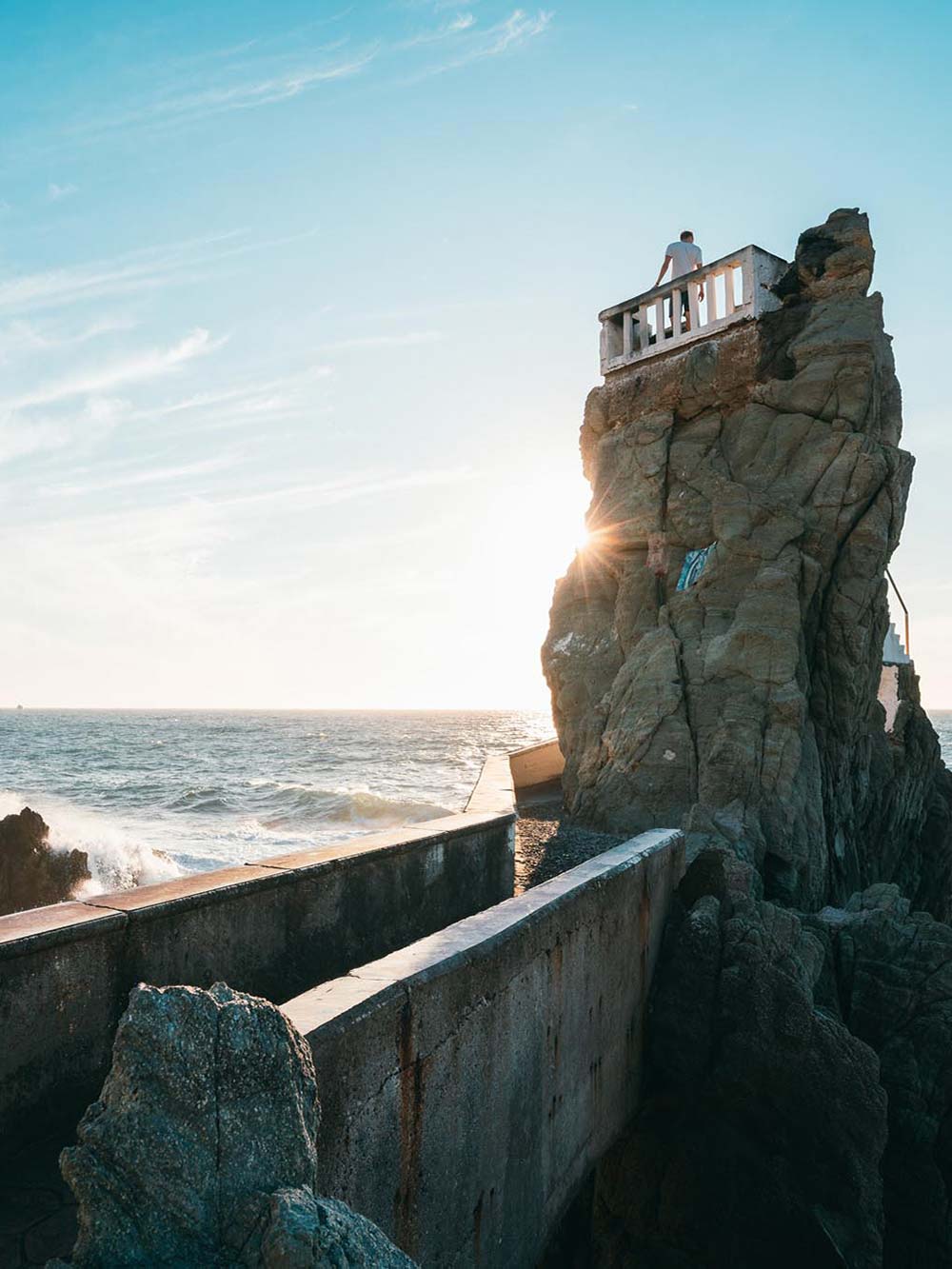 Stone pillar with ocean in background